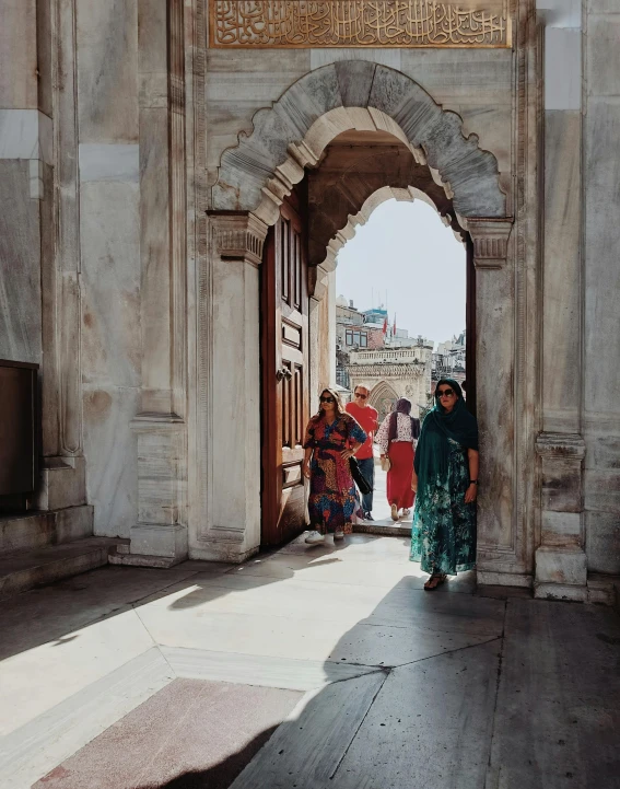 people standing at the entrance to a building in india