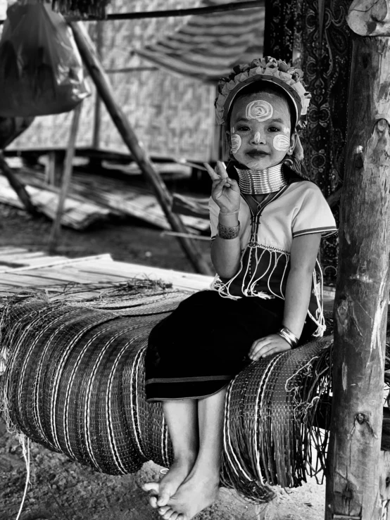 a black and white po shows the back end of a woman sitting on a rope