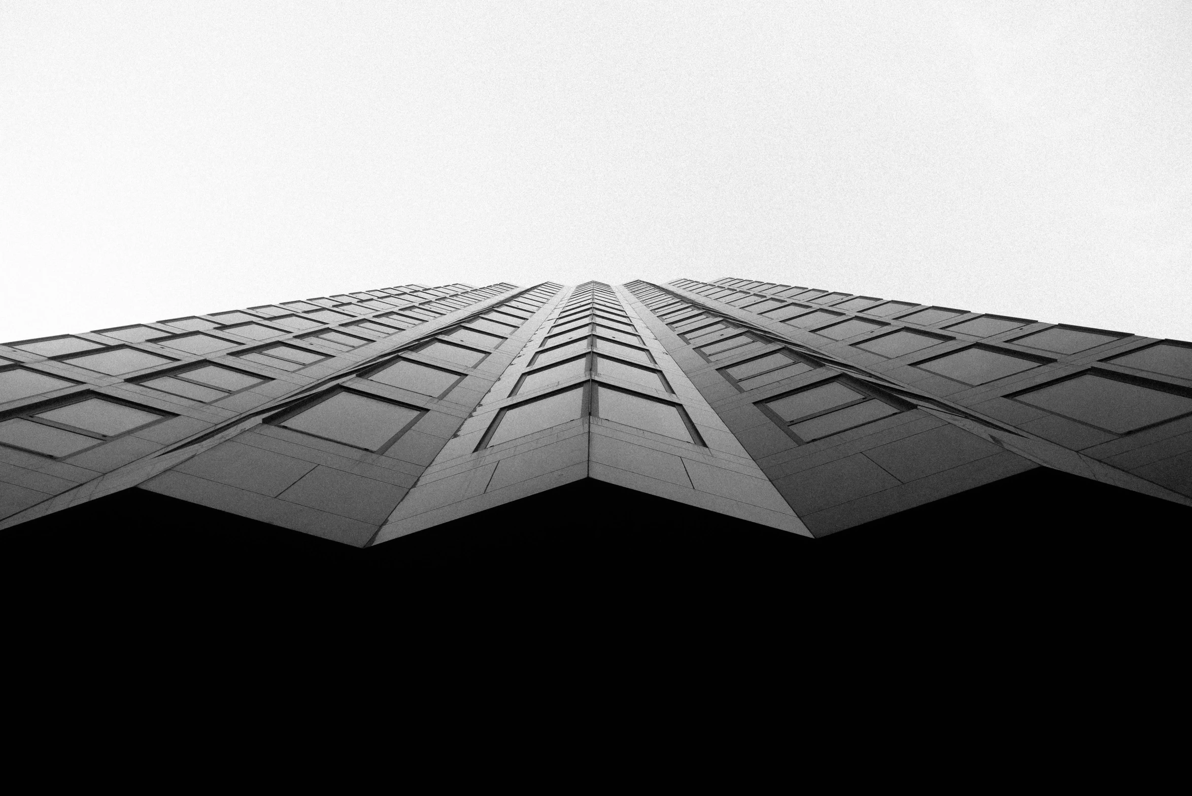 tall buildings with lots of windows in front of a sky