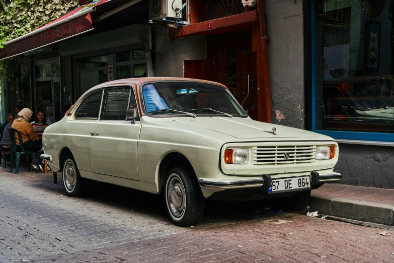 the car is parked outside the small building