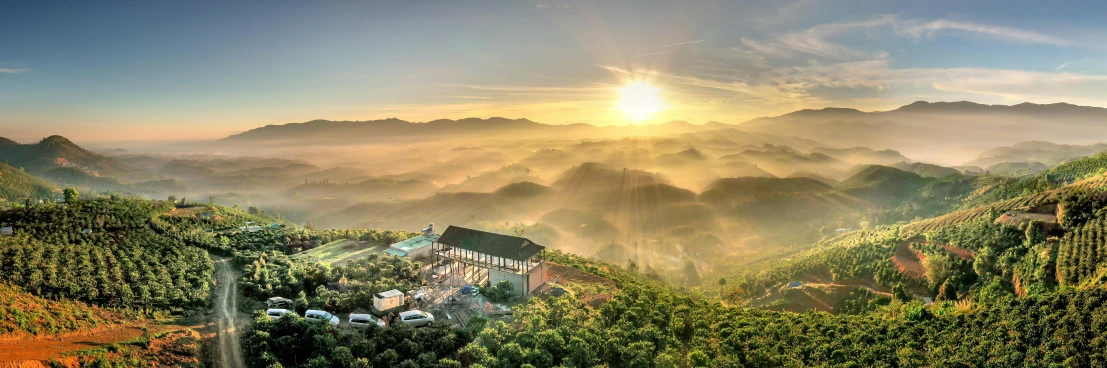 the sun shines brightly through the fog covered mountains