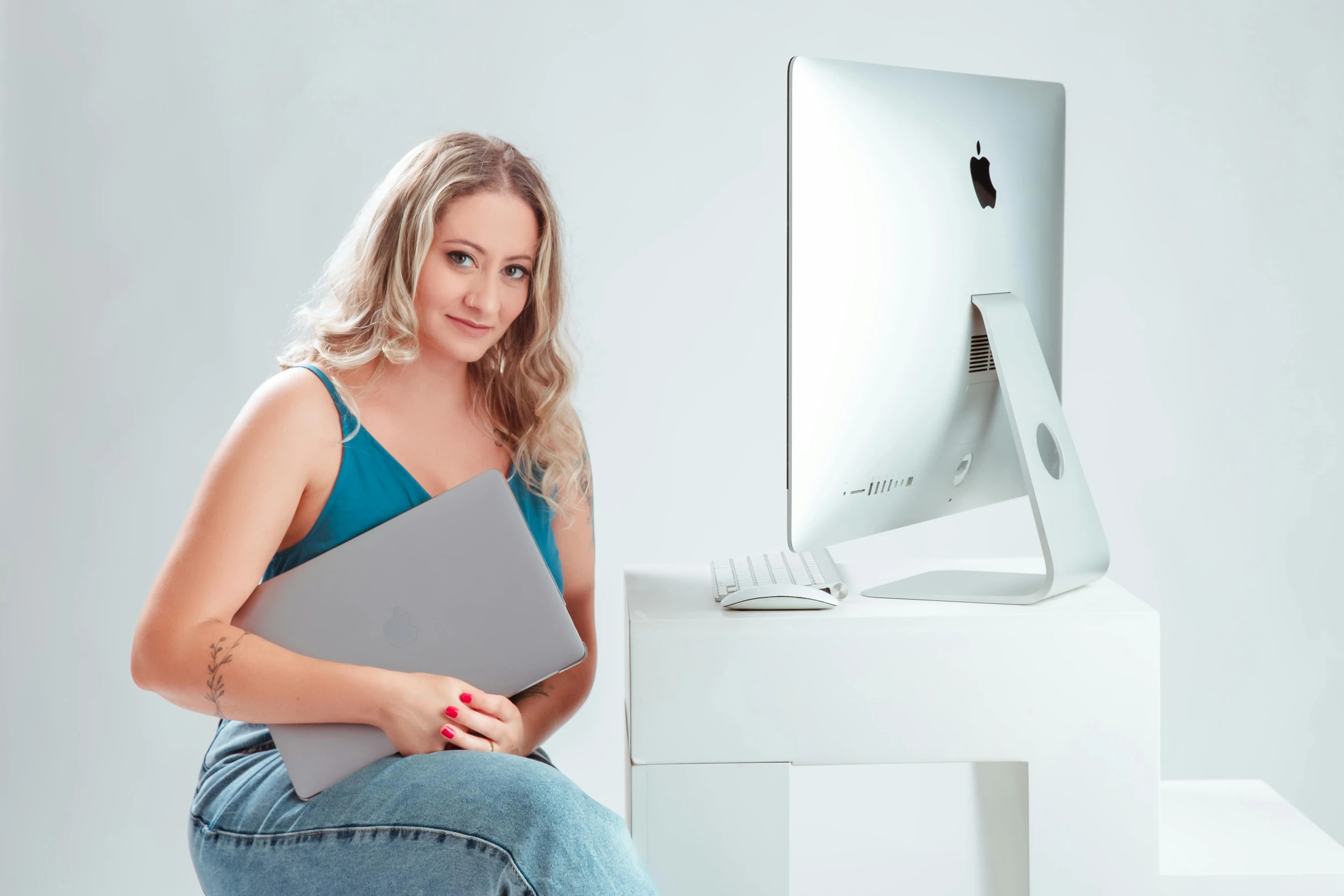 a girl is sitting on a stack of computer parts