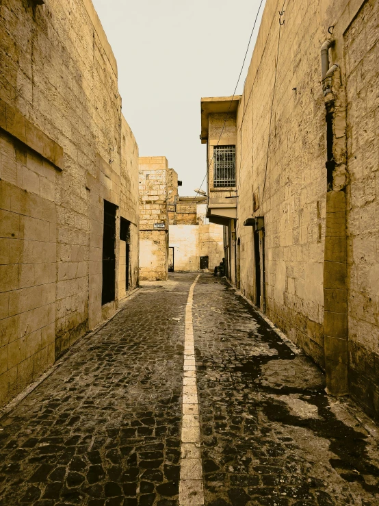 an empty street lined with stone buildings in old town