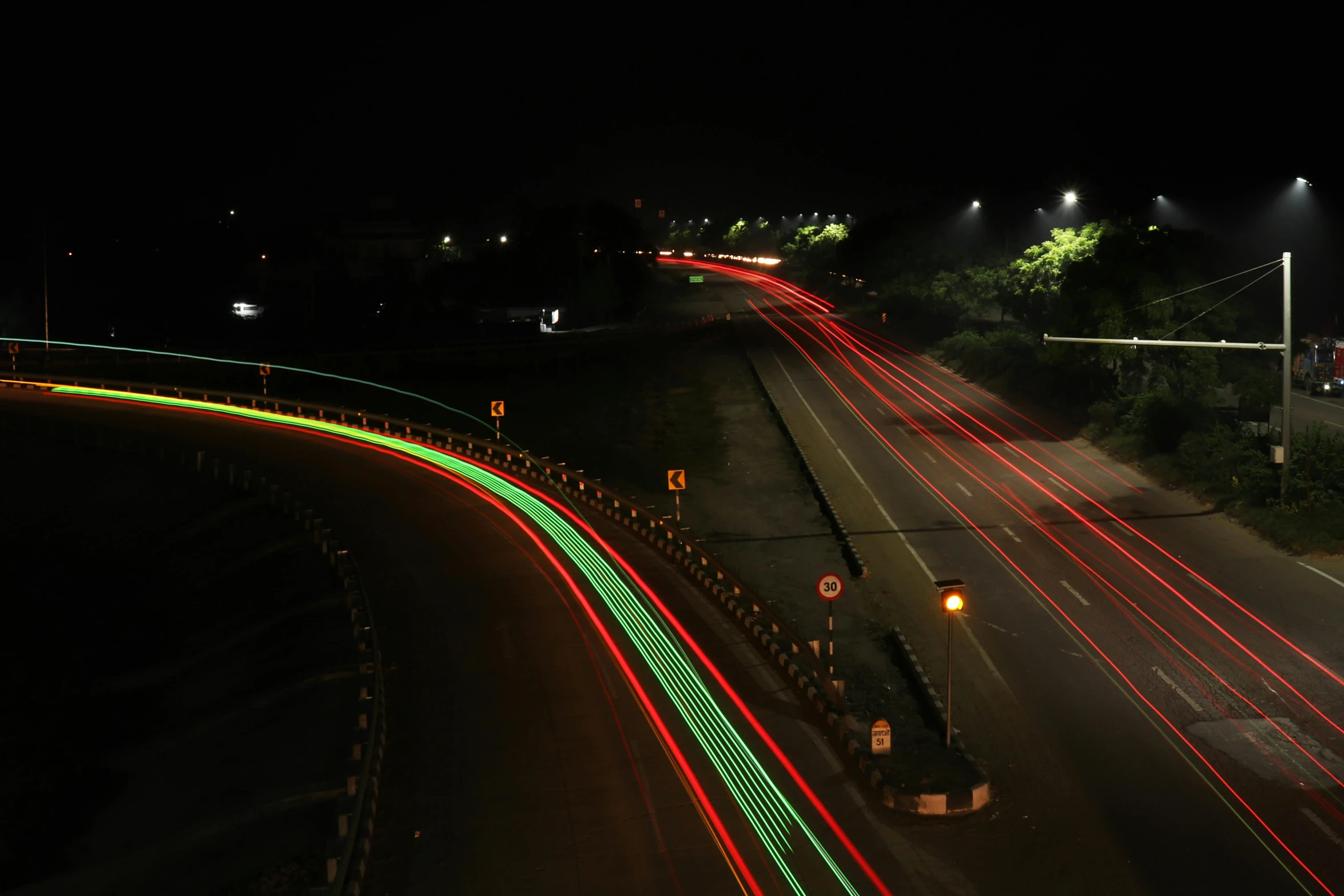 an aerial view of a highway lit with night lights