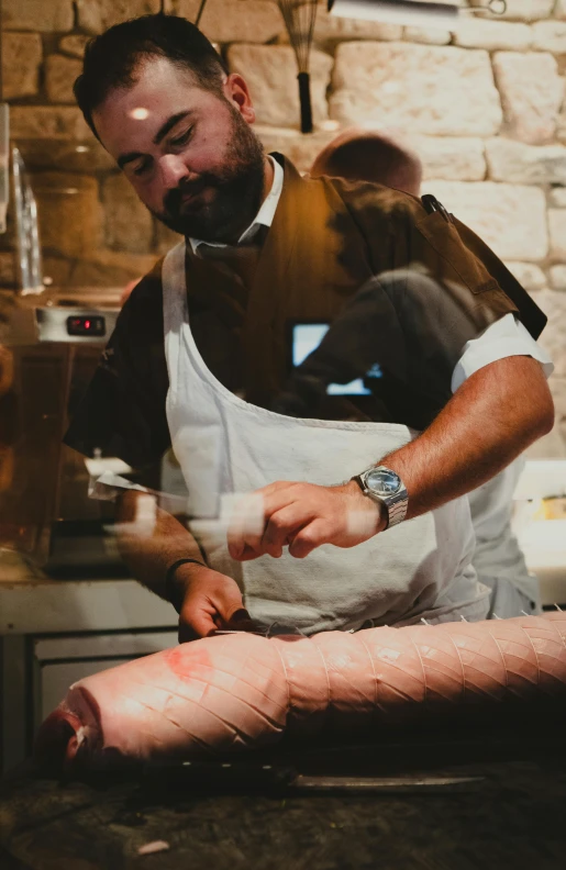 a man in an apron holding a butcher knife