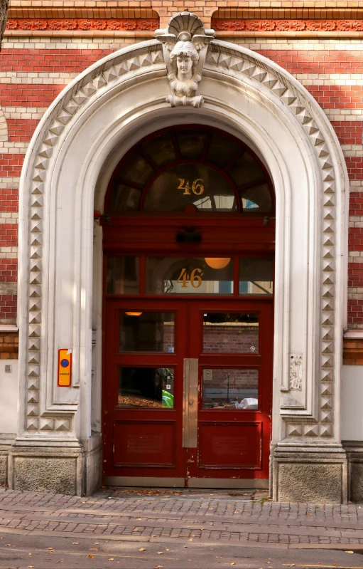 a pair of suitcases outside a doorway with arched entry