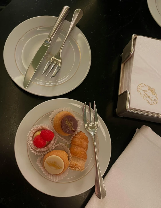 a plate of desserts is sitting on a black table