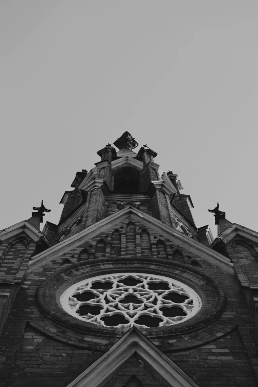 a tall church with an arched window and statues