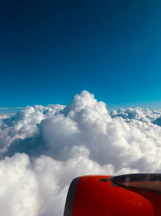 airplane with the window out in the clouds