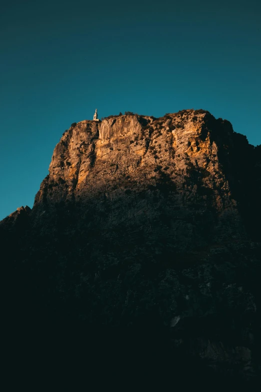 a mountain with a cross on the top