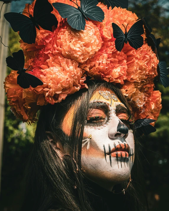 woman with makeup and flowers on her head, wearing erfly makeup