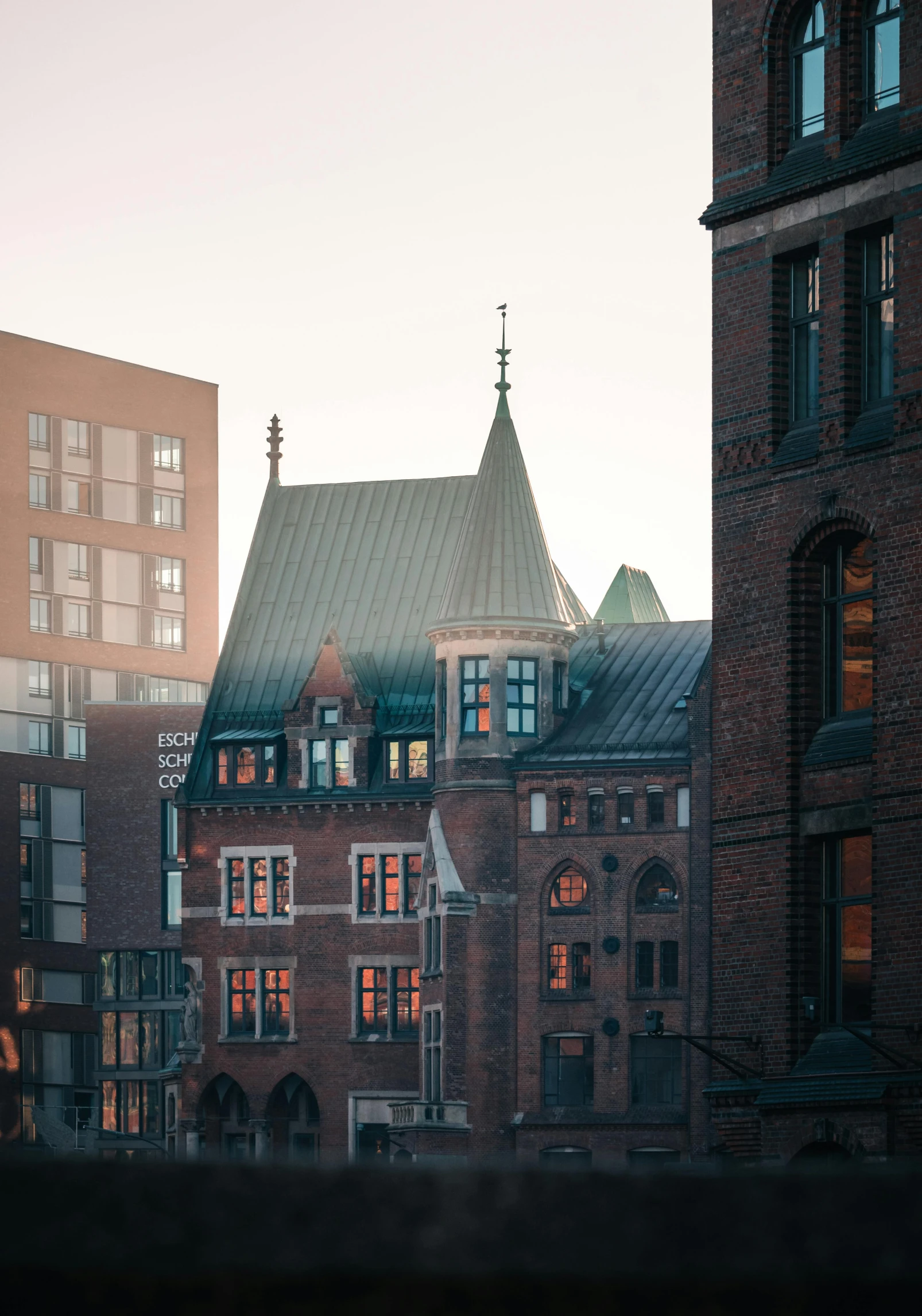 the view from a highrise building in a city with an orange glow