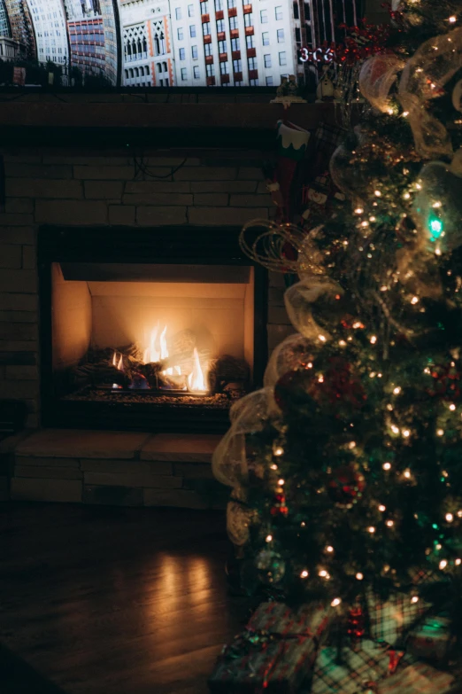 a lighted fireplace with christmas trees and stockings