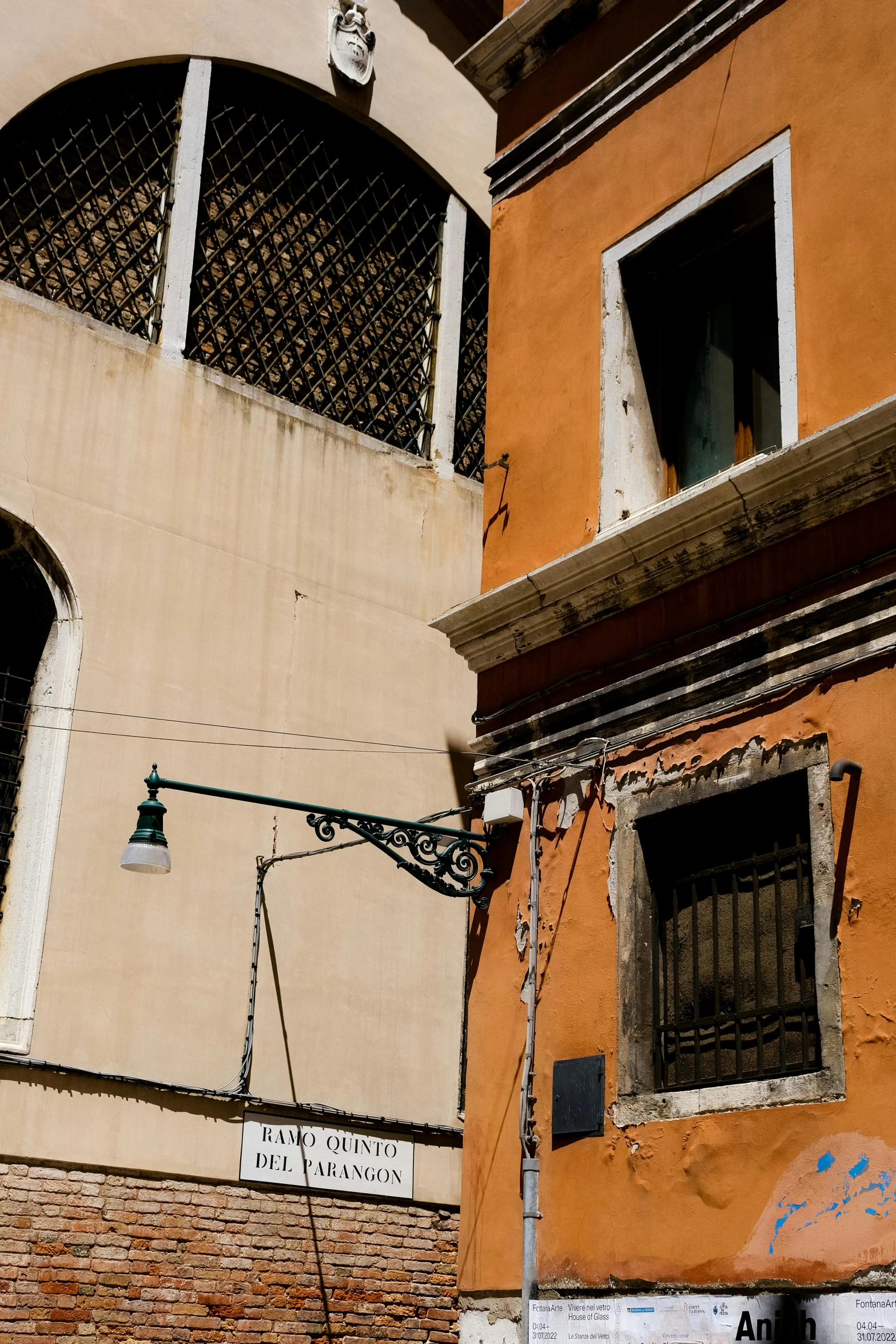 several windows and signs at the bottom of the building