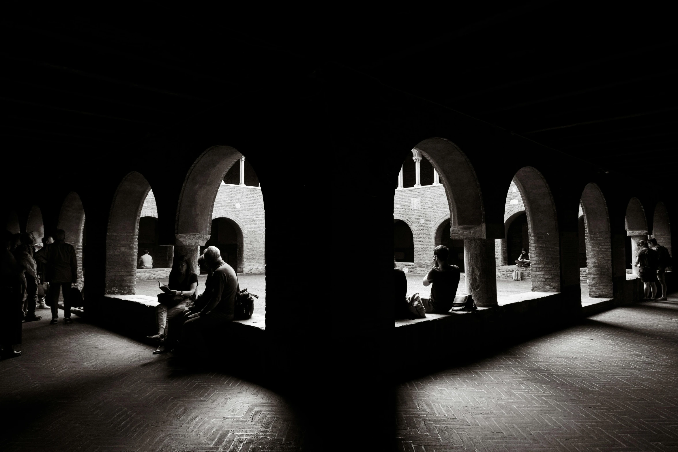 black and white po of people in an old - fashioned building