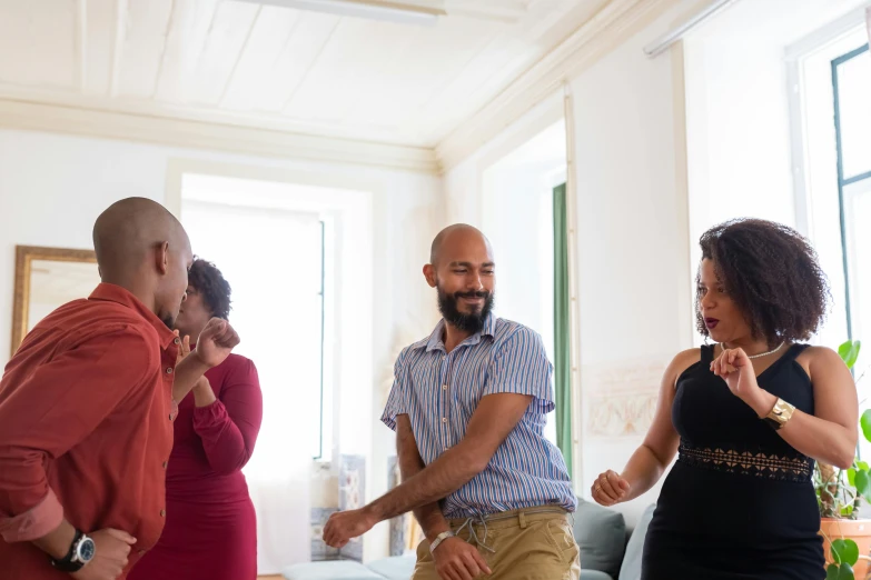 a man and two women and one man is holding hands as she holds her mouth open