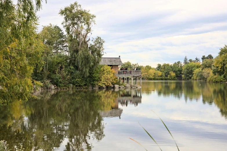 an image of a cabin with lake in foreground