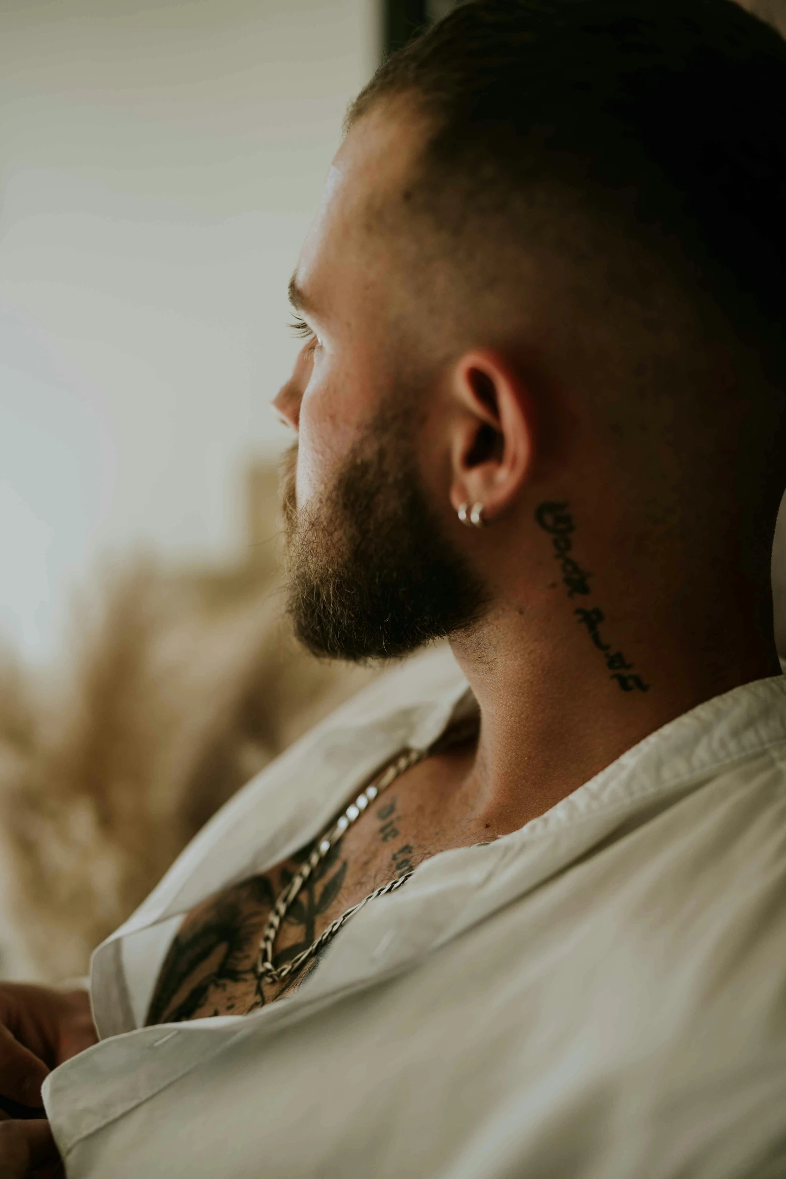 man with a beard and a tattoo on his chest