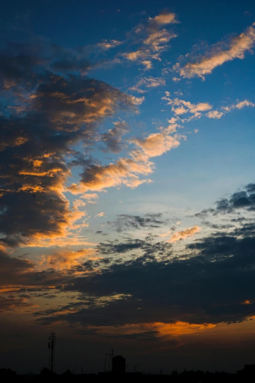 a tall clock tower towering above a cloudy sky