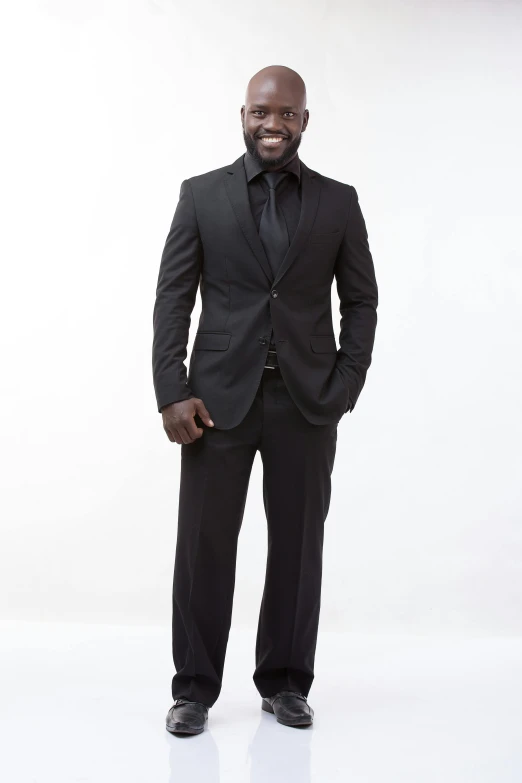 an african man standing in a suit and tie