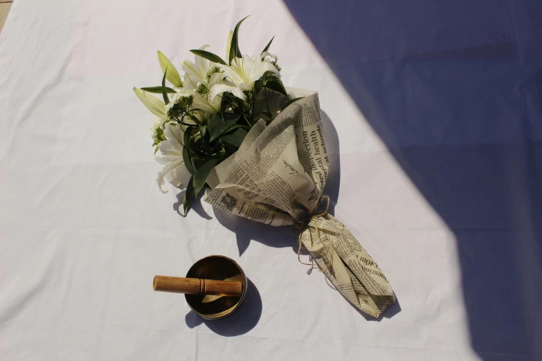 a bouquet of flowers are on a table with a candle