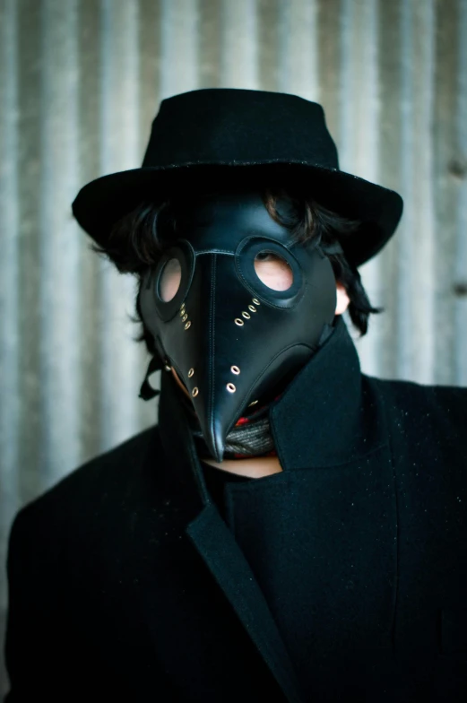 man in black suit with black mask on face