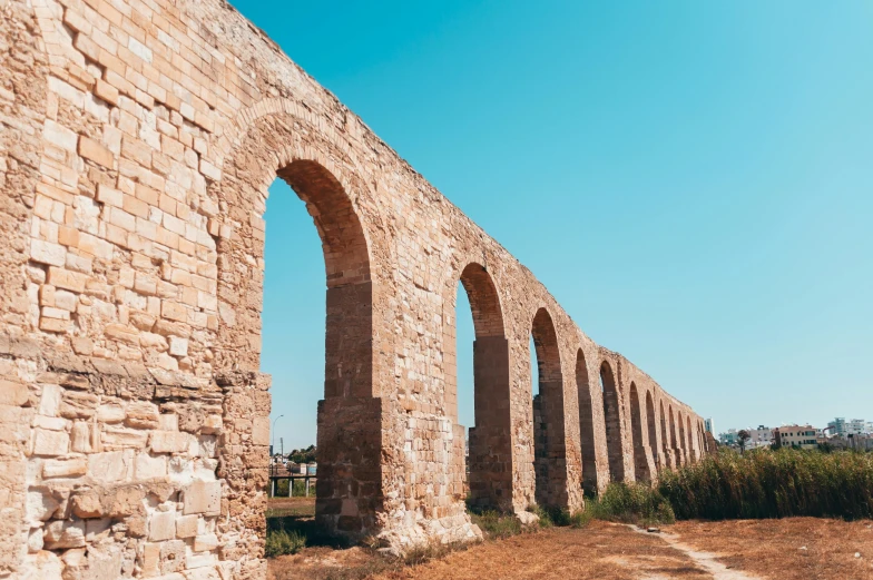 an old stone wall and arched window frames in a field