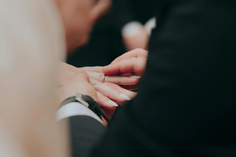 a woman's hands holding another mans hand