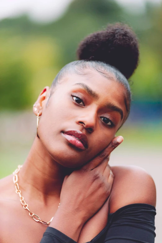 a woman posing with her arms around her neck