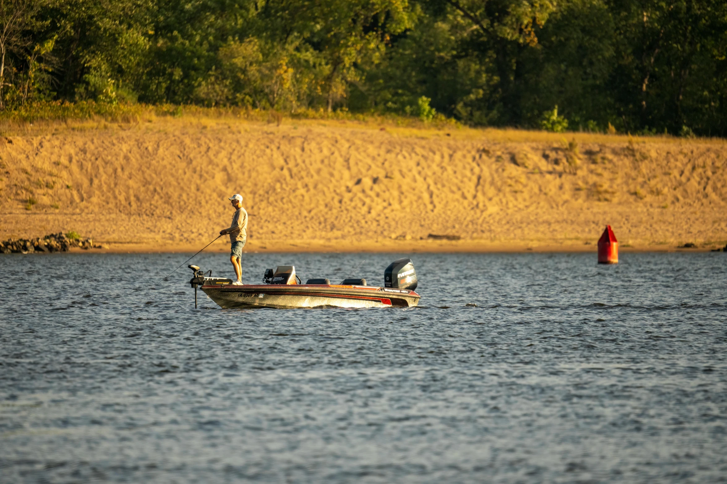 two people standing on top of a small boat in the water