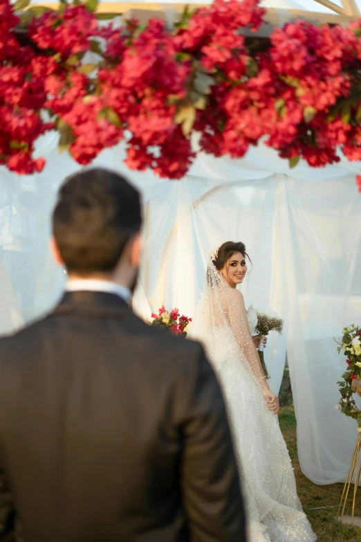 a man standing next to a woman in a wedding dress