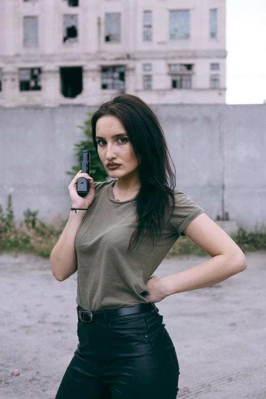 a woman is posing while holding a cell phone