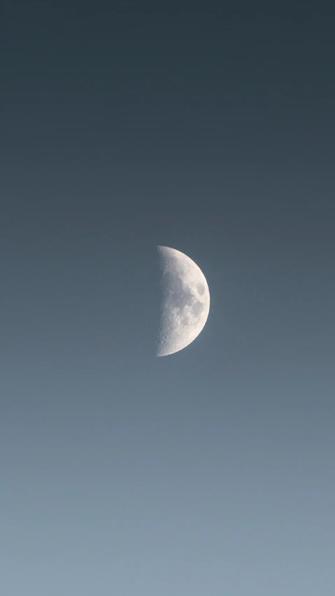the side of a crescent moon in blue sky
