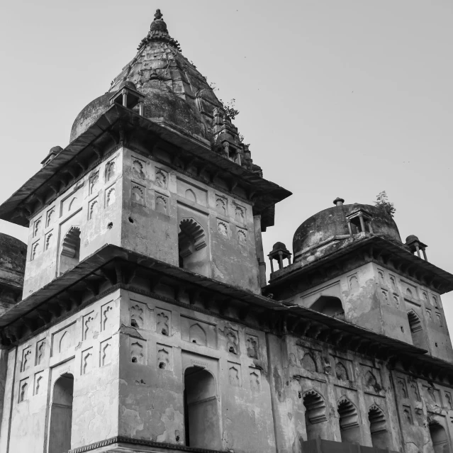 black and white image of tall buildings with a bell tower