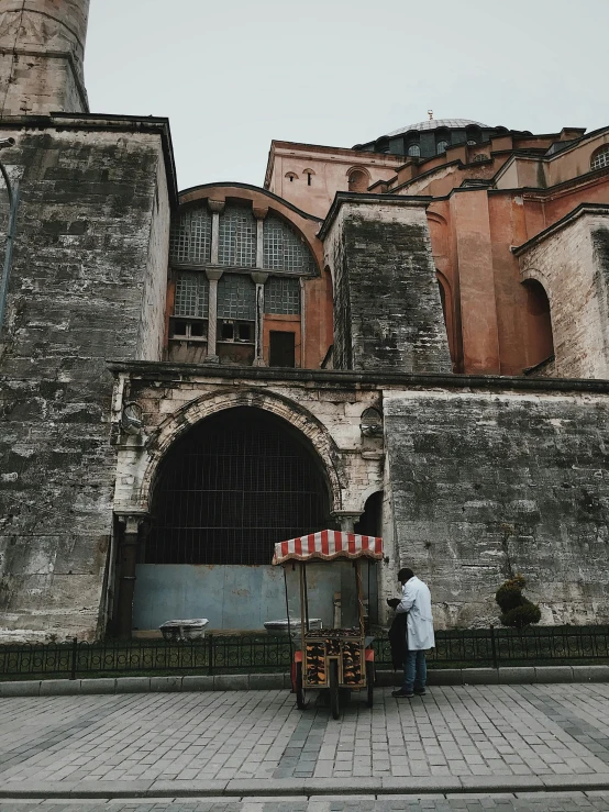 a man is standing outside of an old building