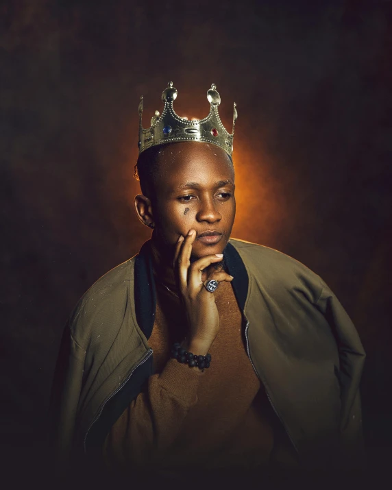 a man wearing a gold crown talking on a cell phone