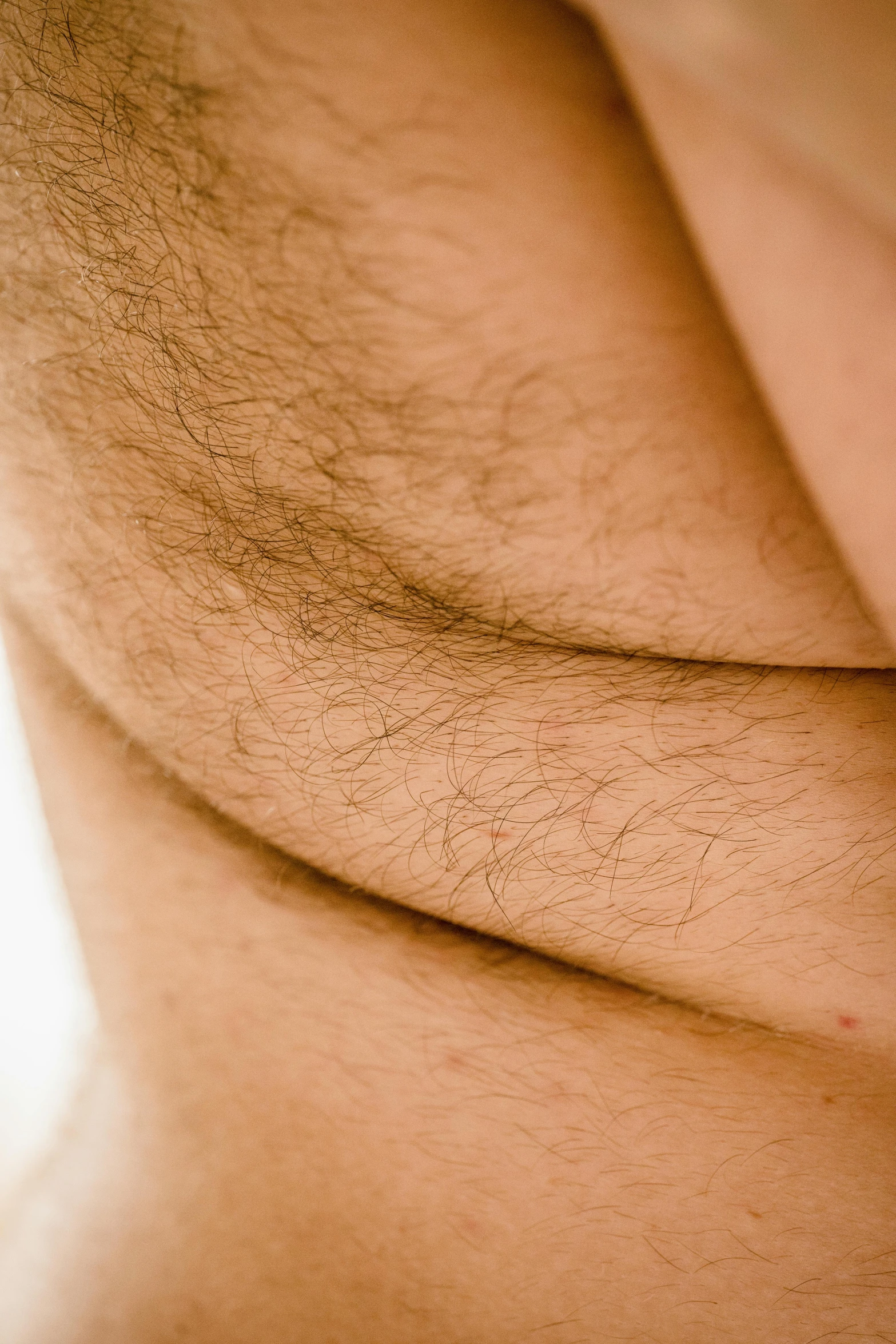 a man wearing his underwear has hairy hairy skin