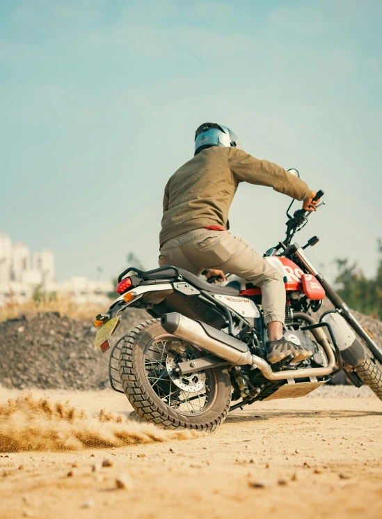 a man riding a motorcycle through the desert