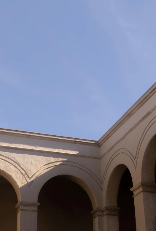 this is an airplane flying in the air above some arches