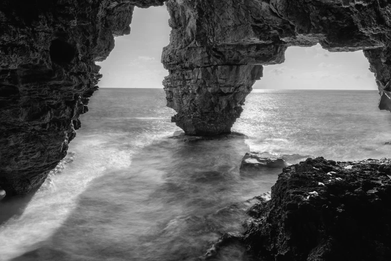 a person standing on a cliff over looking the ocean