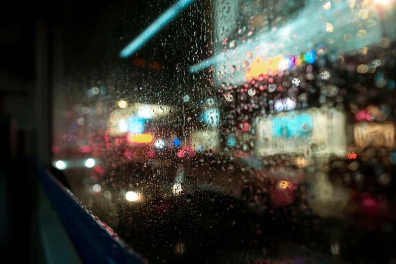 blurred image of buildings and traffic on rainy night