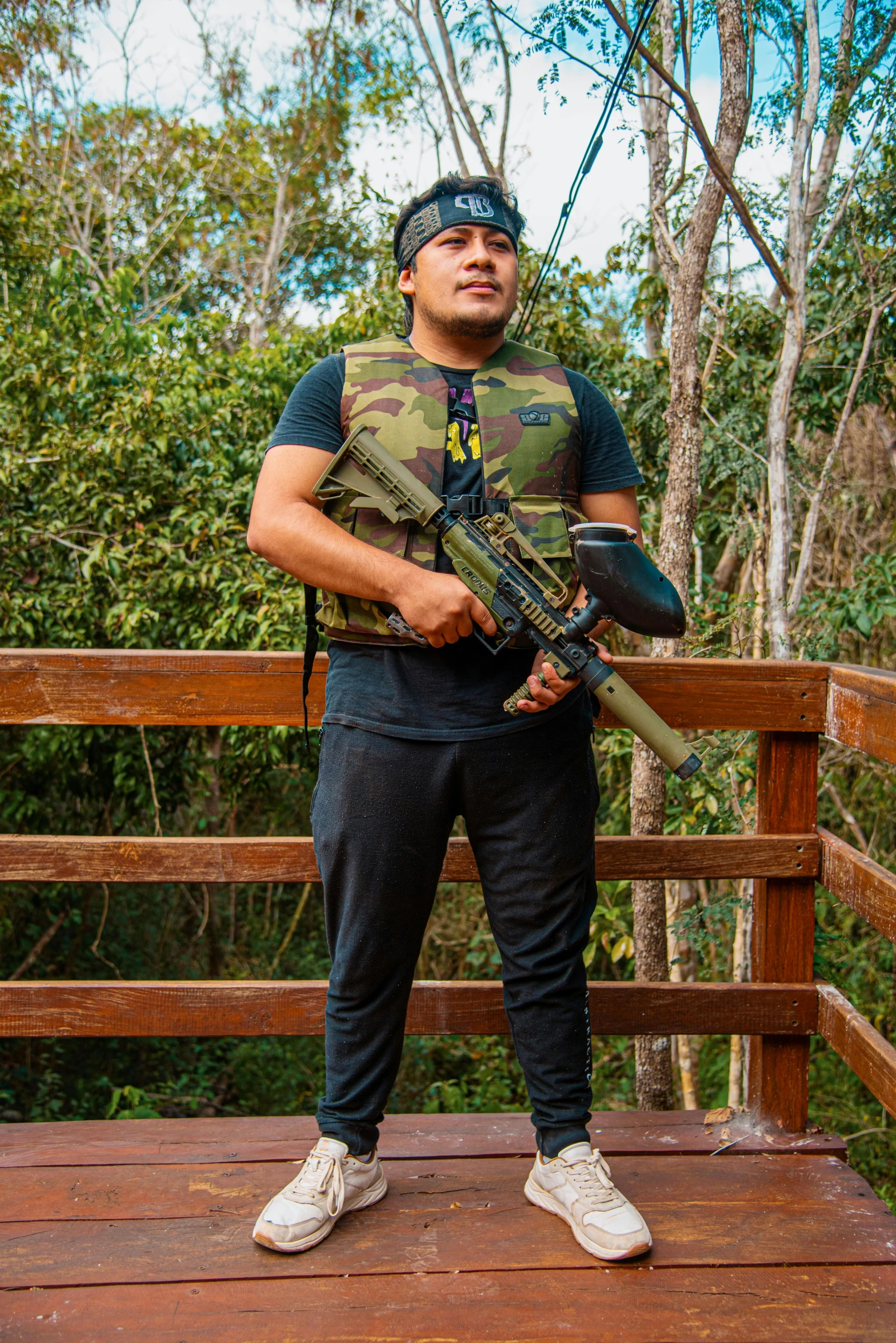 a person on a wooden bridge holding a rifle