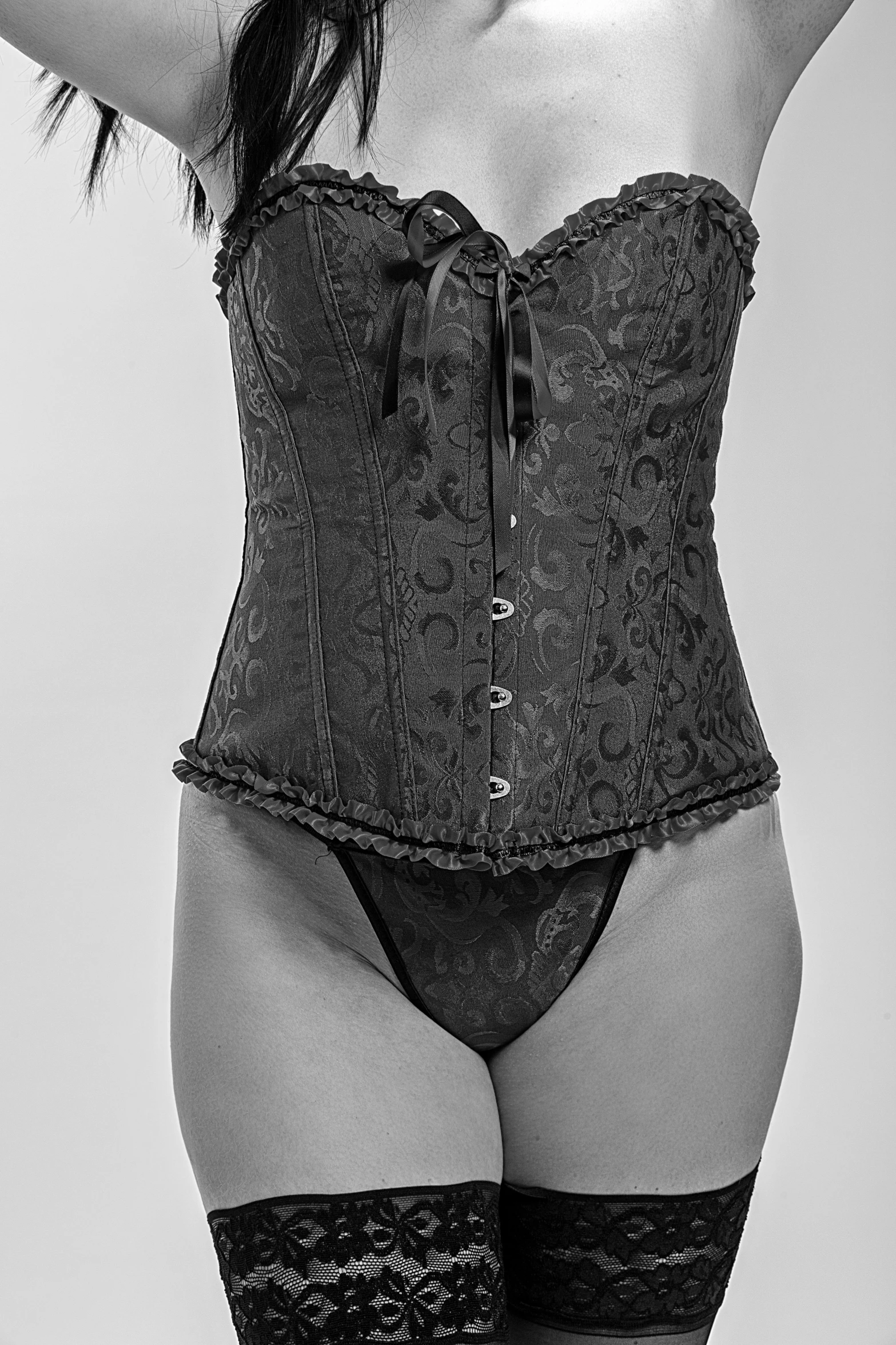 a woman in lingerie wearing black  with laced corset