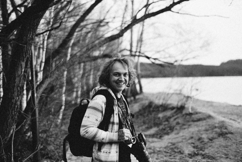 a person wearing a scarf is standing by water