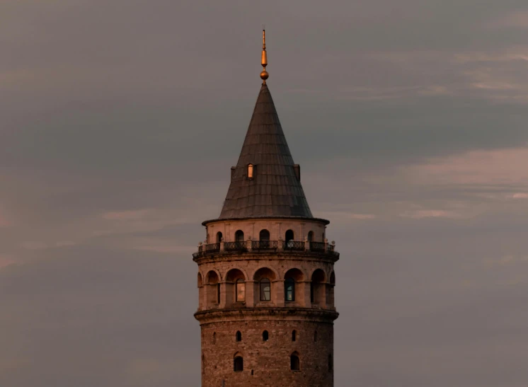 there is a tall tower with a steeple at sunset