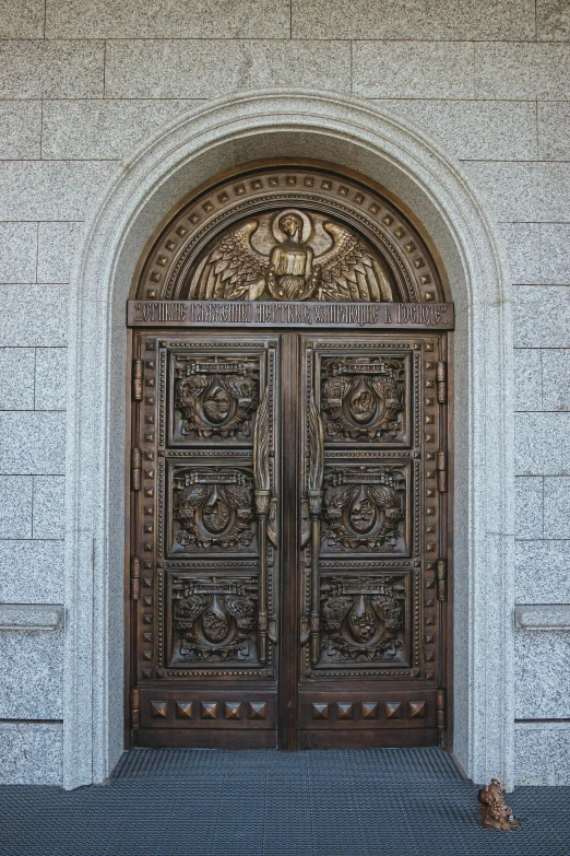 two golden doors that have some cats sitting underneath them