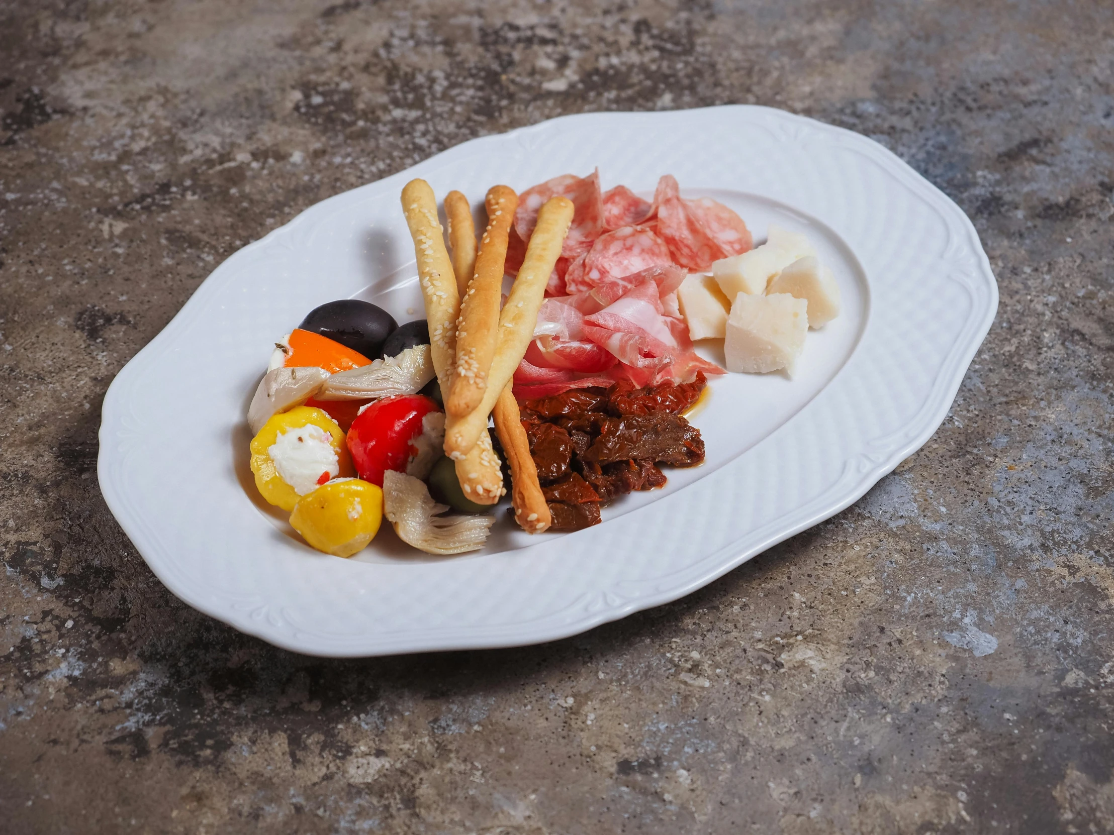 an empty plate filled with meat and cheeses