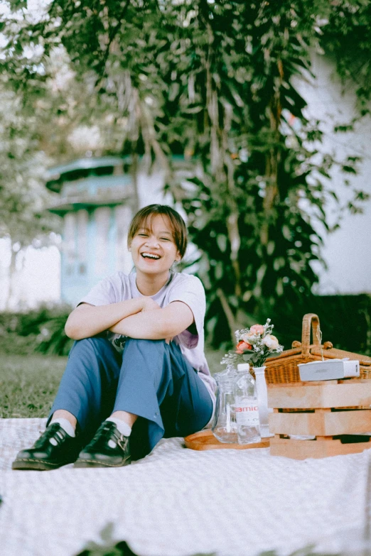 a boy is sitting down in the grass