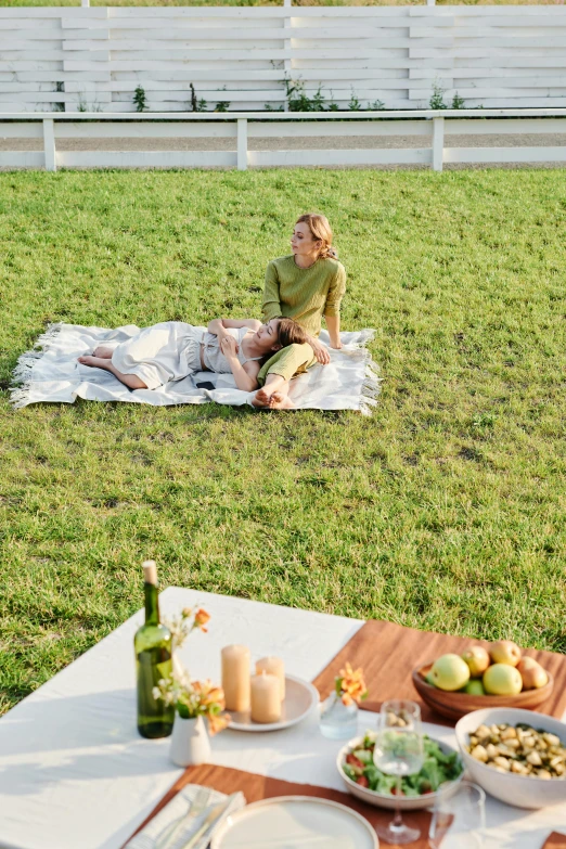 a woman is sitting on the lawn outside