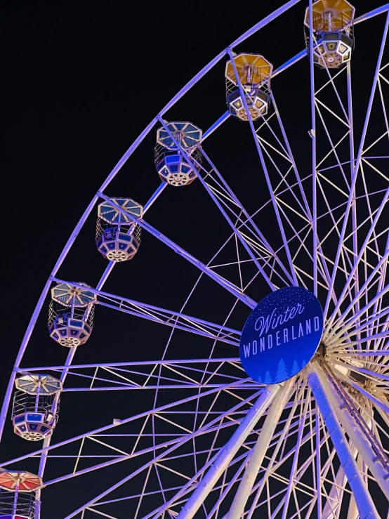 there is a ferris wheel lit up at night